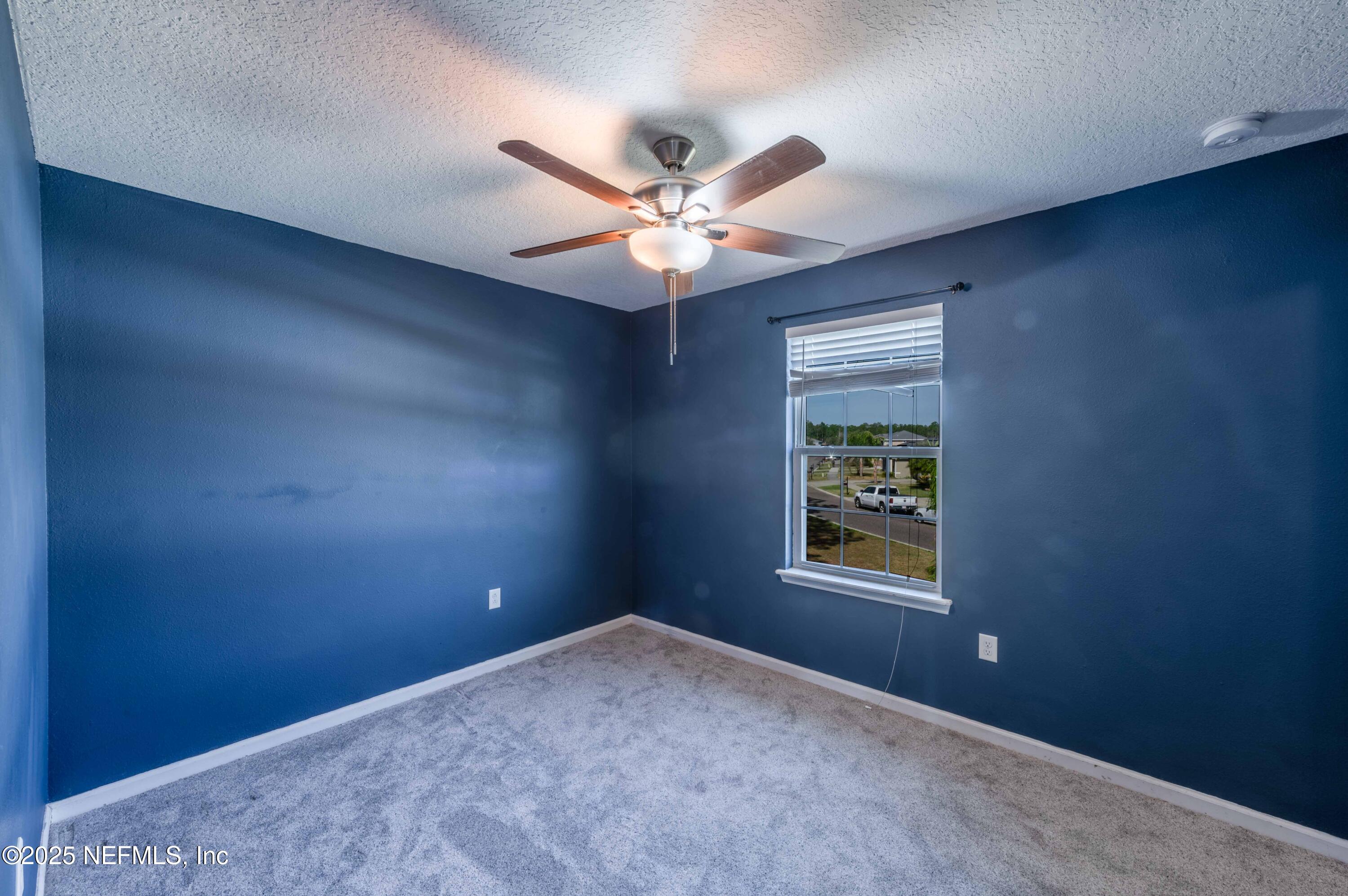 77041 Cobblestone Drive Yulee, FL 32097 - Photo 15 of 23 an empty room with windows and fan