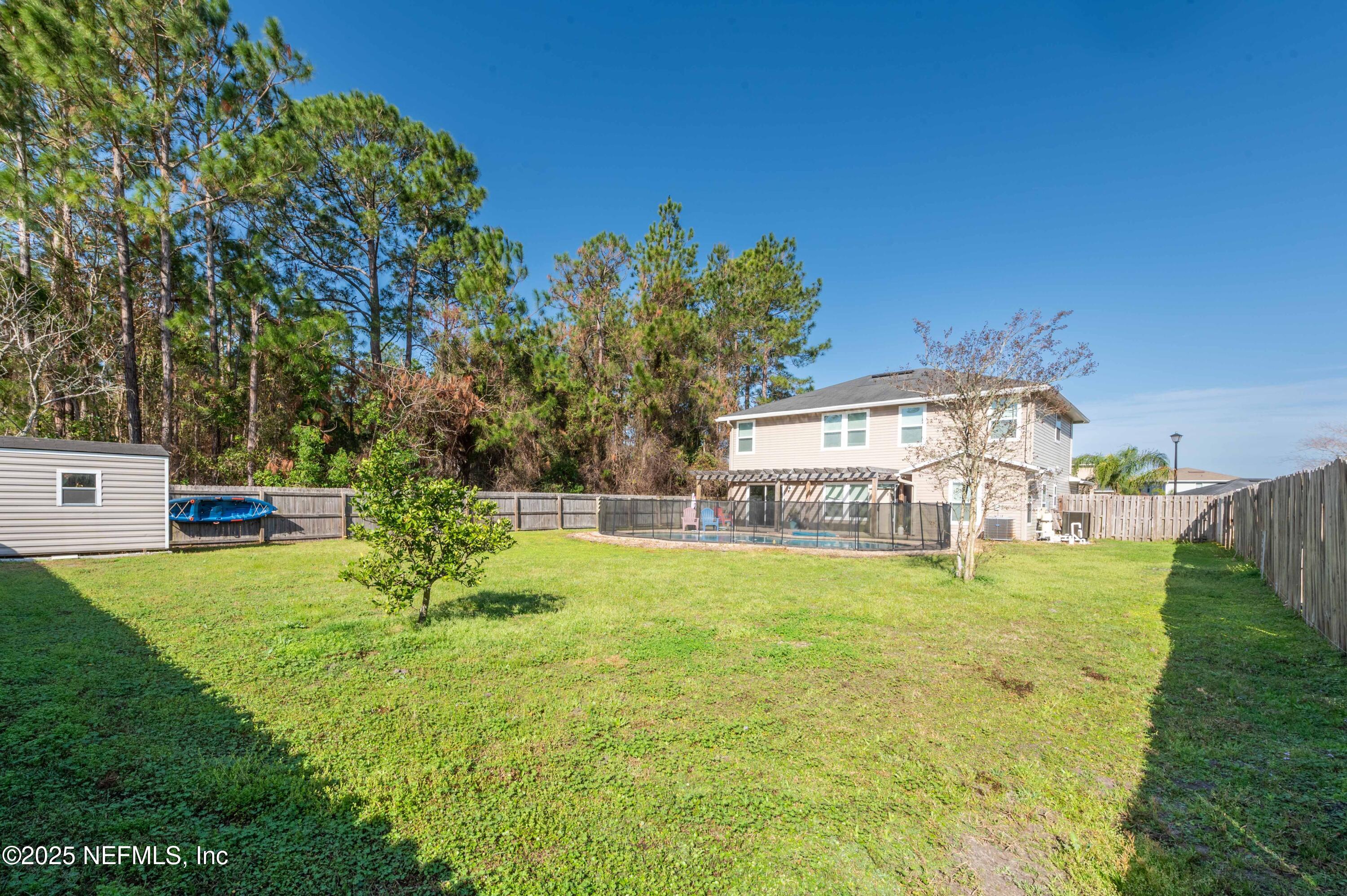 77041 Cobblestone Drive Yulee, FL 32097 - Photo 21 of 23 a view of a house with a yard