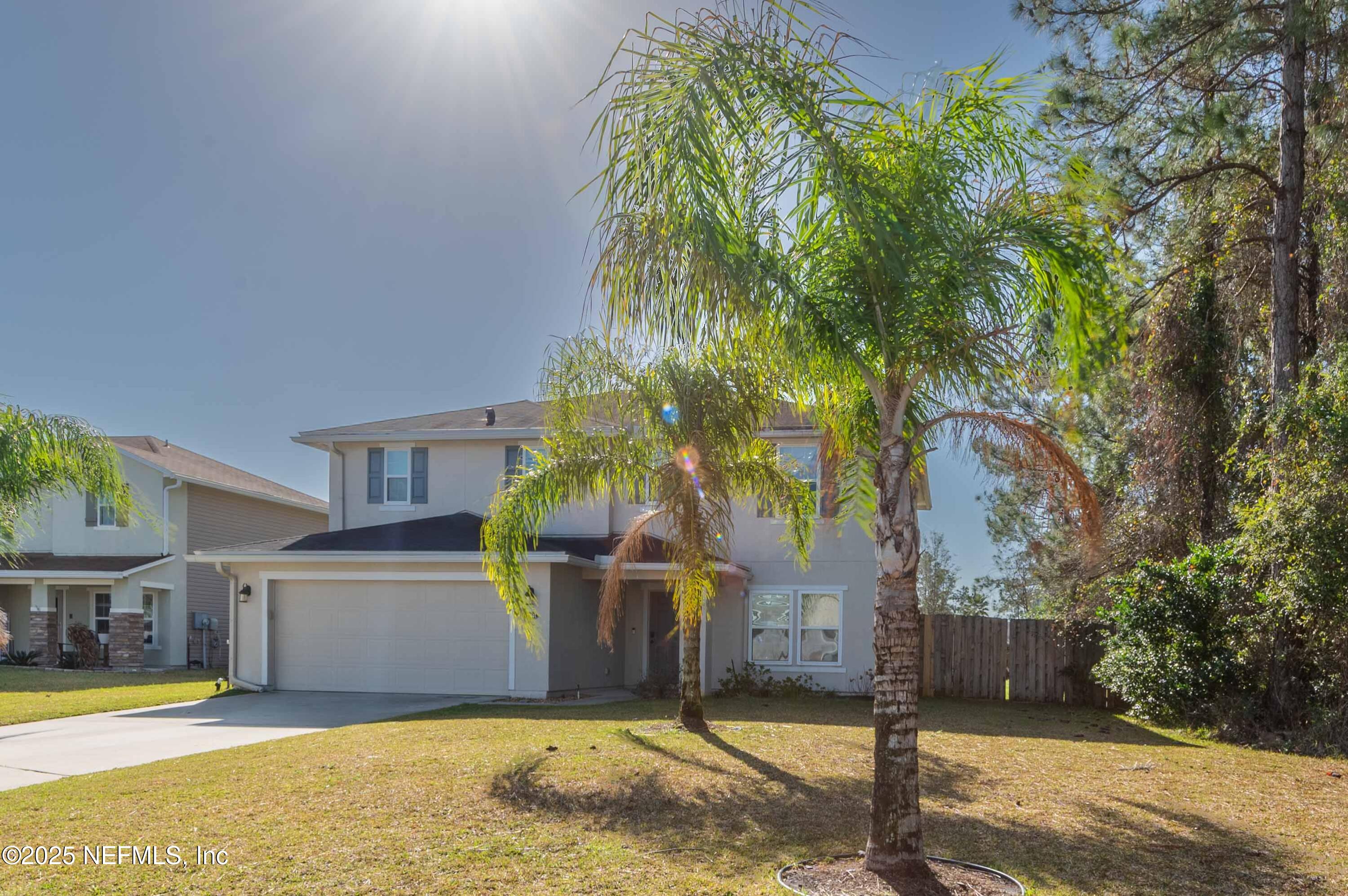 77041 Cobblestone Drive Yulee, FL 32097 - Photo 3 of 23 a view of a house with a yard