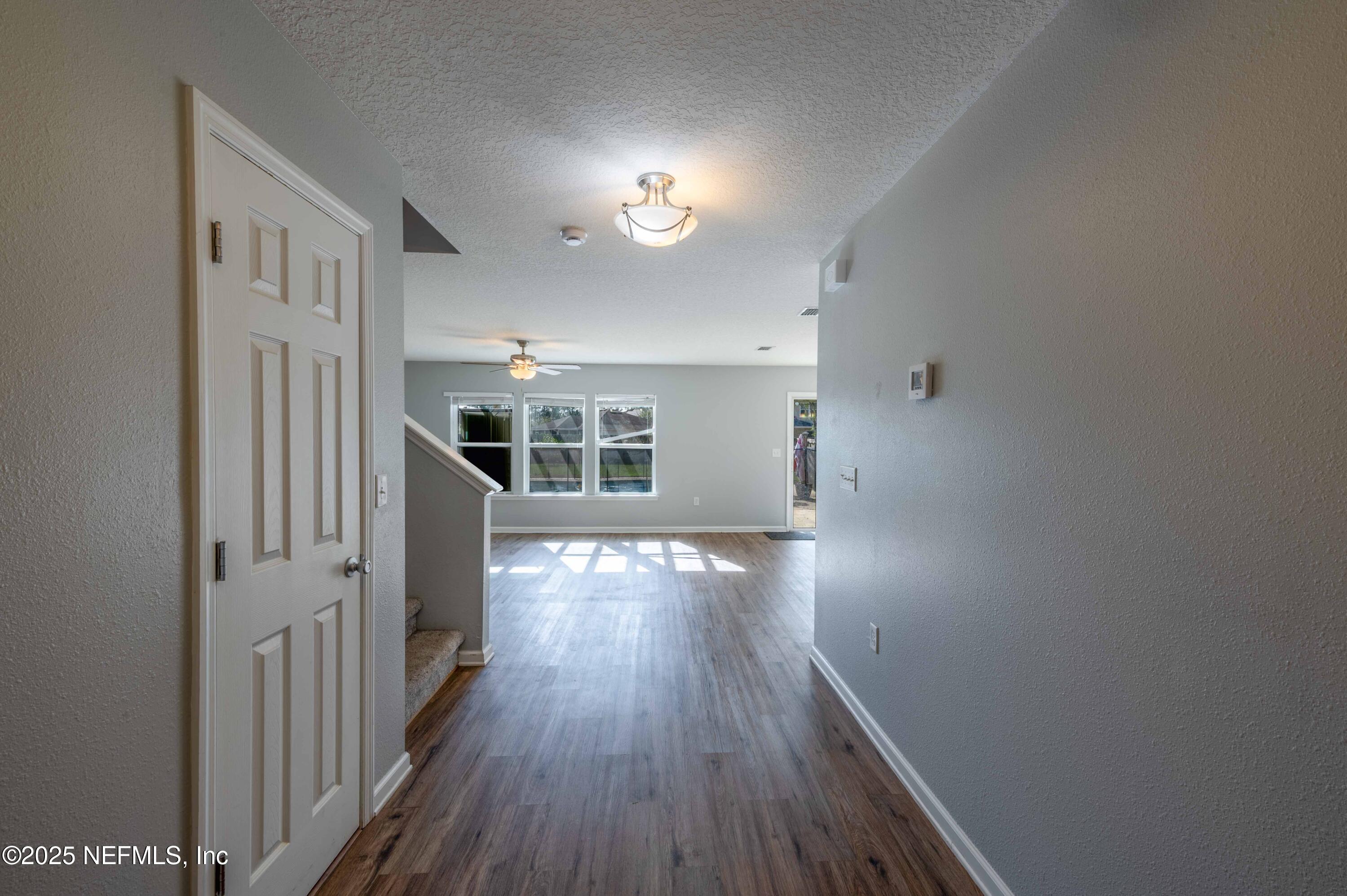 77041 Cobblestone Drive Yulee, FL 32097 - Photo 4 of 23 a view of a livingroom with wooden floor and staircase