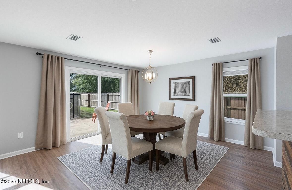 77041 Cobblestone Drive Yulee, FL 32097 - Photo 6 of 23 a dining room with furniture window and wooden floor