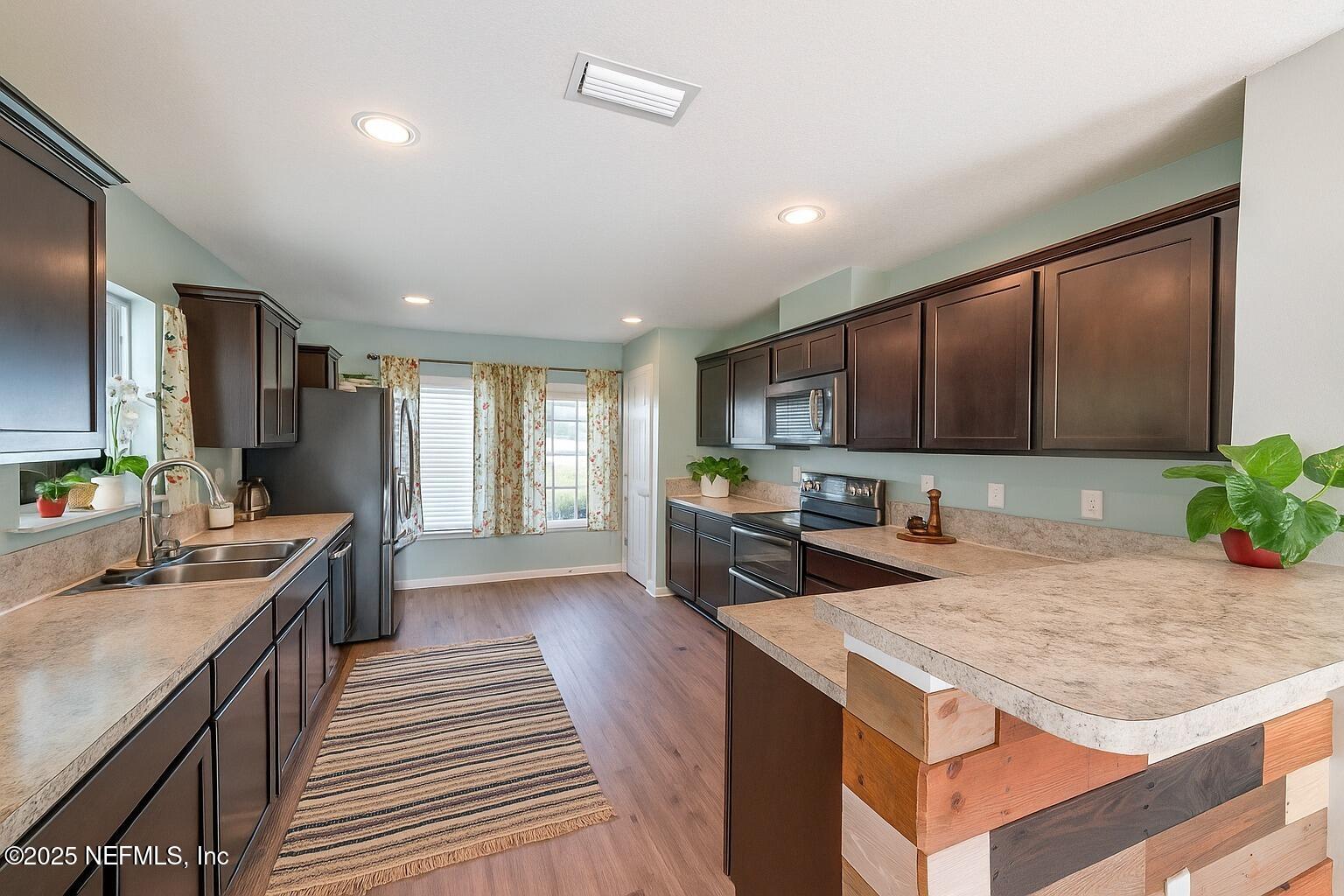 77041 Cobblestone Drive Yulee, FL 32097 - Photo 7 of 23 a kitchen with sink stove and refrigerator
