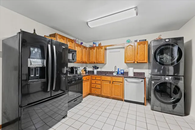 a kitchen with stainless steel appliances granite countertop a refrigerator and a stove top oven