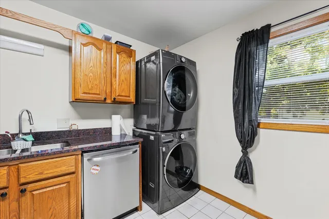 a utility room with sink dryer and washer