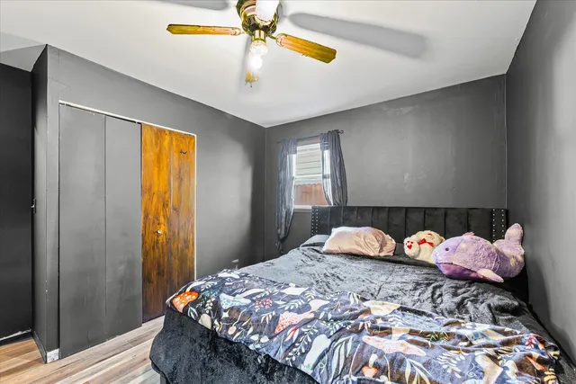 a bedroom with a bed and a chandelier