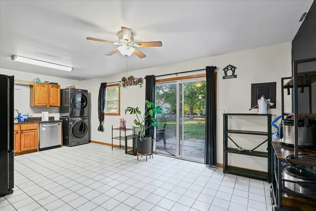 a room with lots of white furniture and a chandelier
