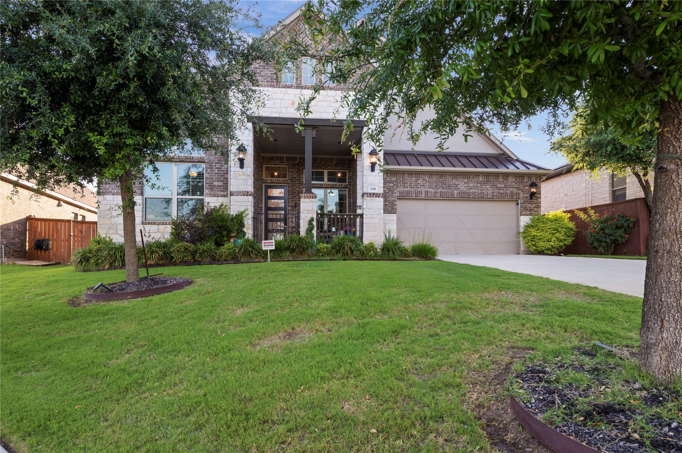138 Rpd Spgs Cove Georgetown, TX 78628 - Photo 2 of 37 a front view of a house with a yard and trees