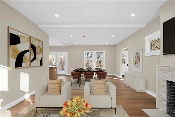 a living room with fireplace furniture and a large window