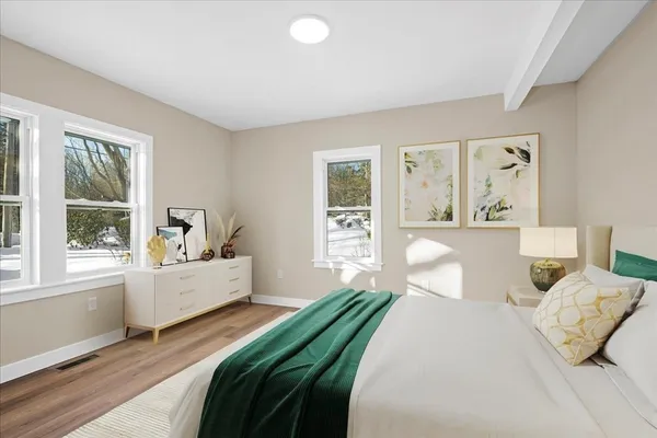 a bedroom with a large bed and a large window