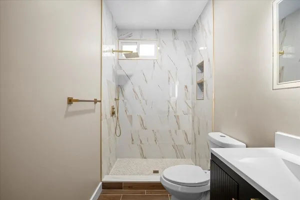 a bathroom with a toilet and a shower
