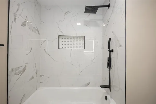 a bathroom with a bathtub and a shower