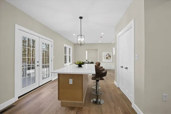 a view of a livingroom with furniture wooden floor windows and hallway