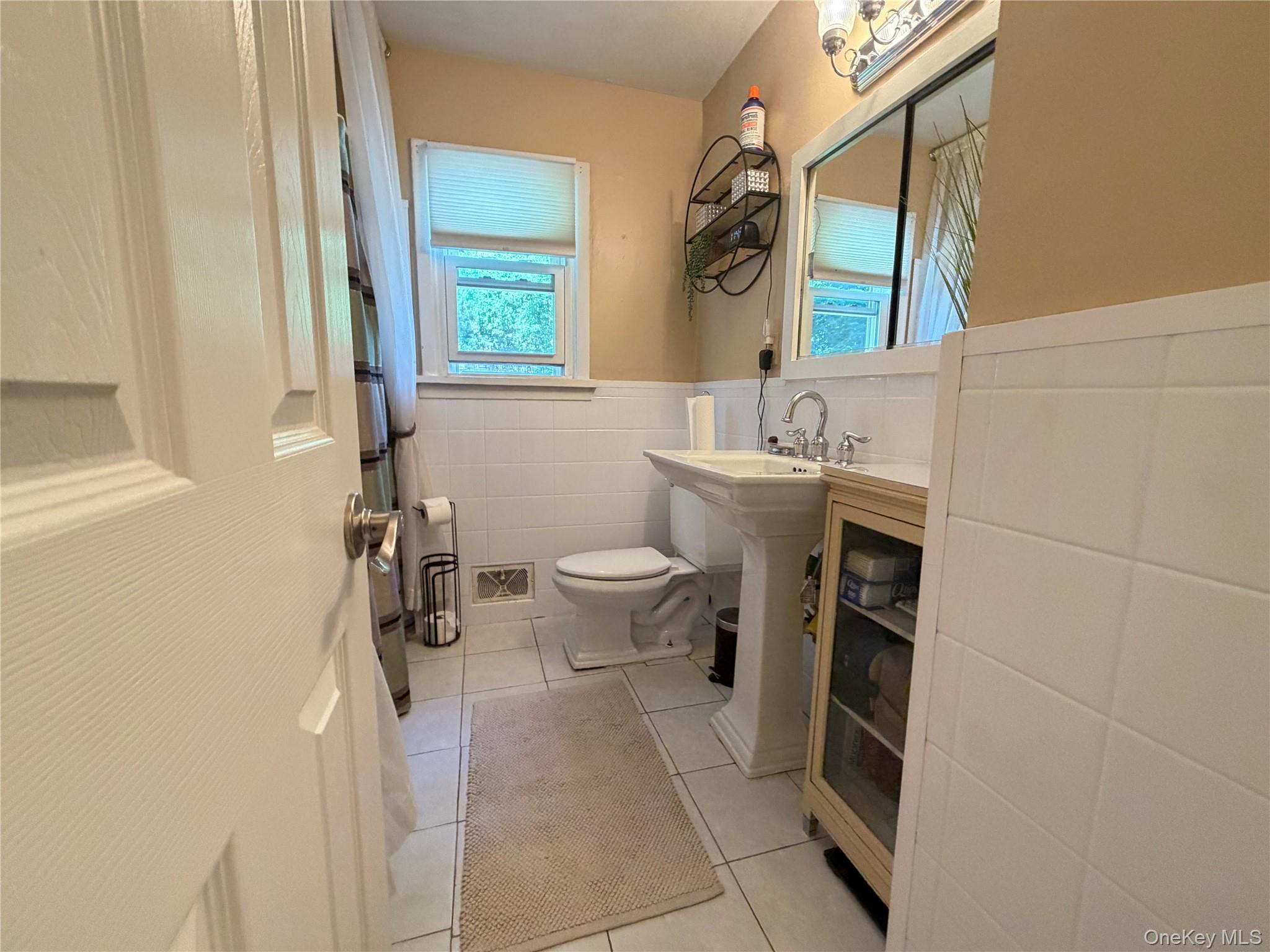 17 Mallory Road Spring Valley, NY 10977 - Photo 14 of 26 a bathroom with a sink toilet and window