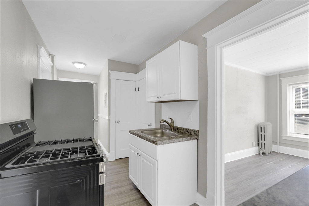 120-122 Central Street Springfield, MA 01103 - Photo 21 of 30 a kitchen with a stove and a refrigerator