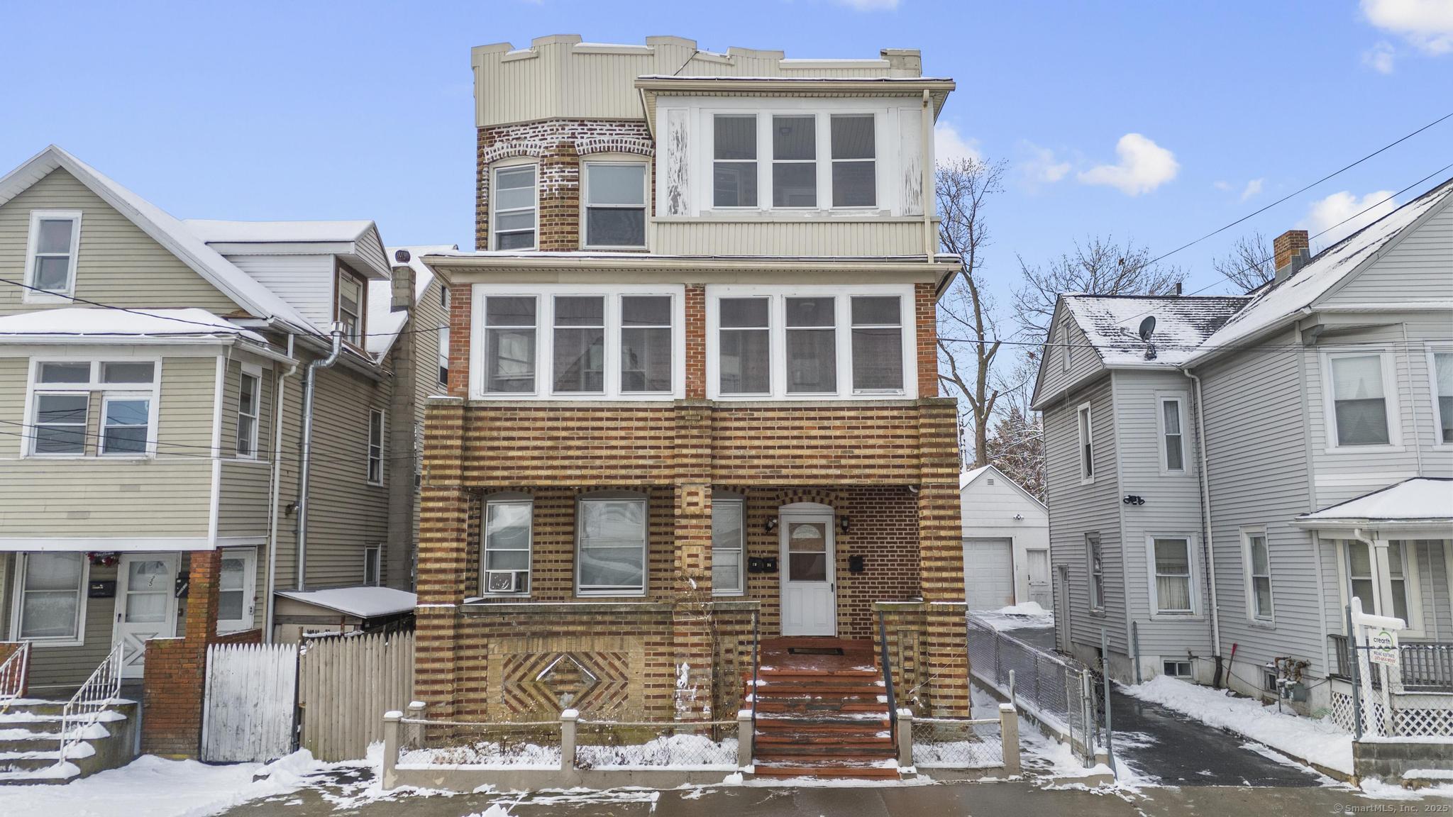 29-31 Sedgewick Street Bridgeport, CT 06606 - Photo 1 of 1 a front view of a house with many windows