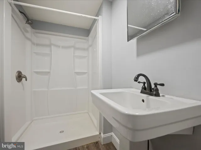 a white bath tub sitting next to a white sink