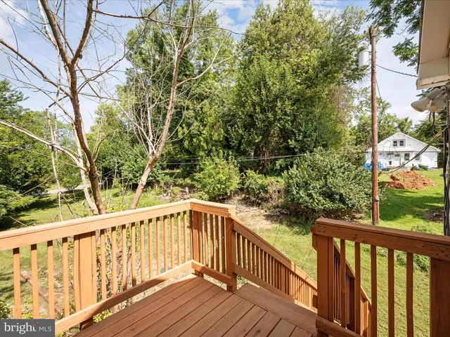a view of balcony with wooden floor and fence