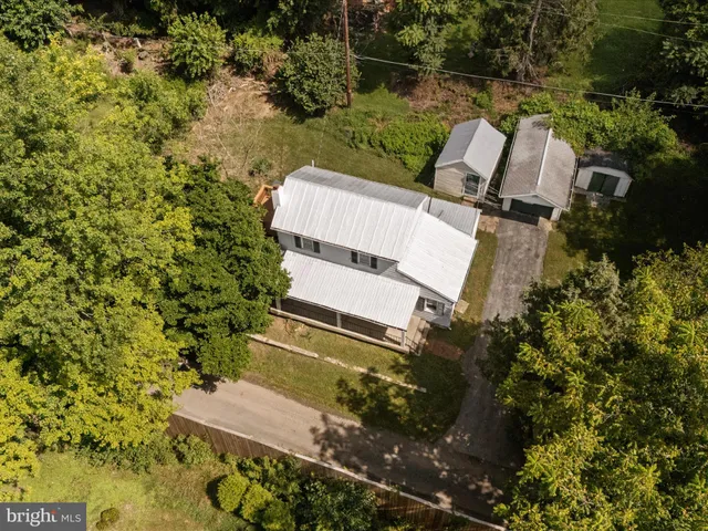 an aerial view of a house with a yard and lake view