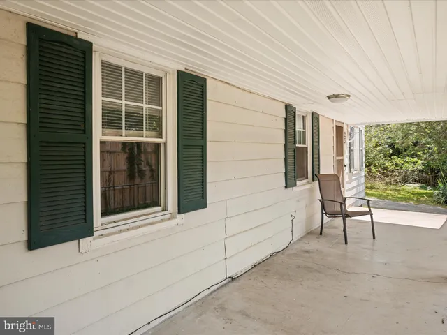 a view of a porch with a table and chair