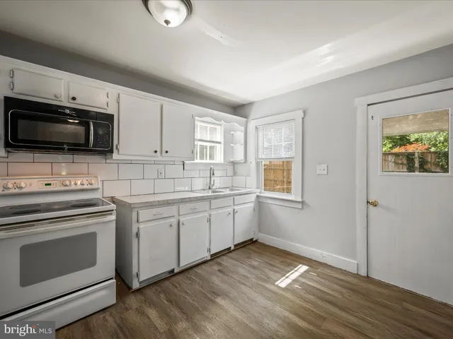 a kitchen with a sink stove and microwave