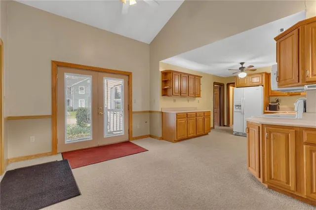 a view of an empty room with a kitchen