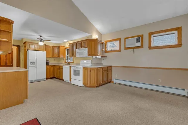 a kitchen with stainless steel appliances granite countertop a refrigerator a stove and a sink