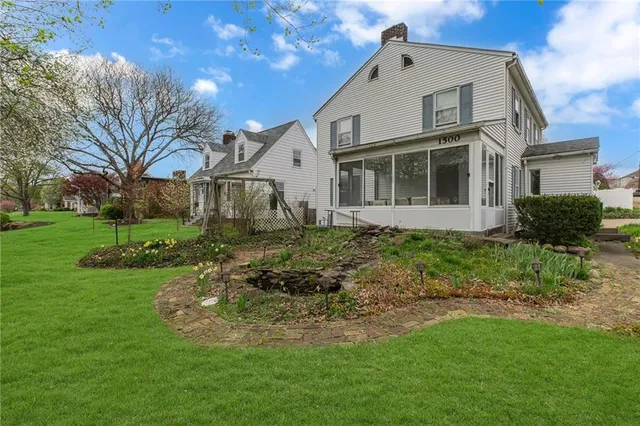a view of a house with a yard and garage