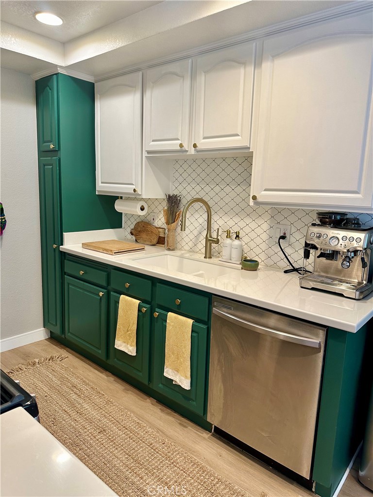 1045 East 3rd Street, Unit 4 Long Beach, CA 90802 - Photo 11 of 20 a kitchen with stainless steel appliances granite countertop a sink stove and cabinets