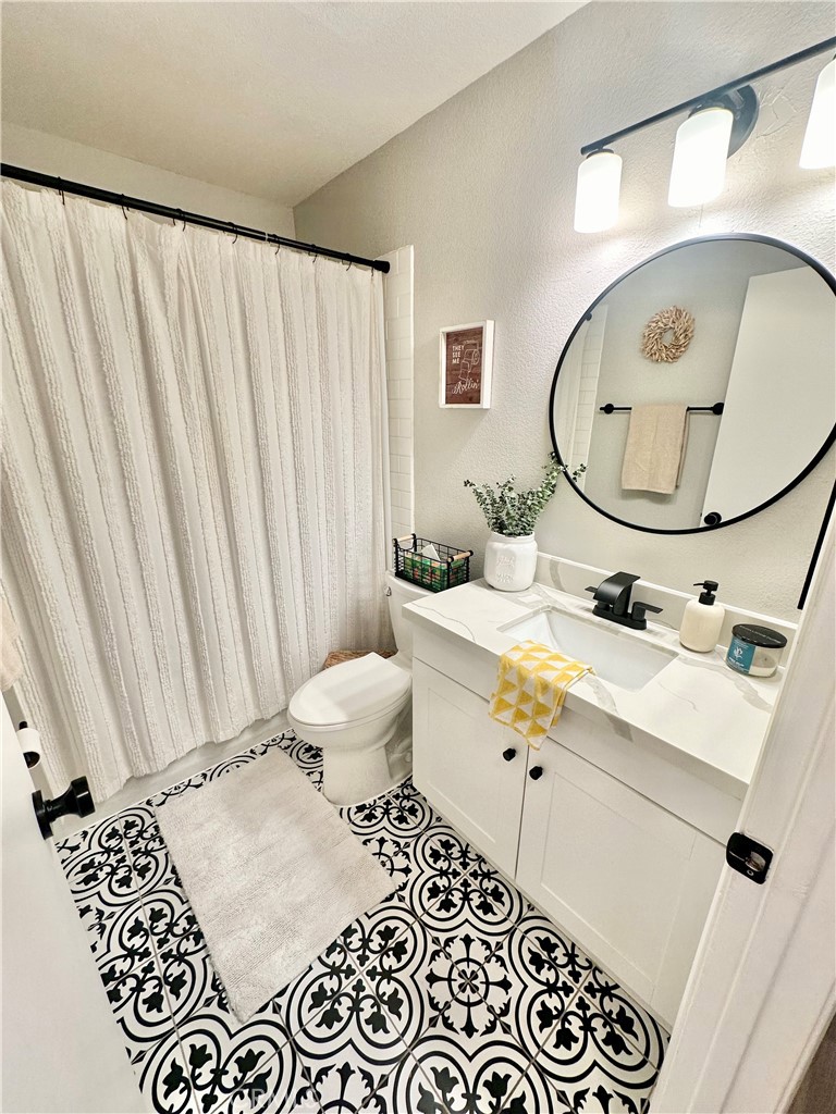 1045 East 3rd Street, Unit 4 Long Beach, CA 90802 - Photo 16 of 20 a bathroom with a sink and a mirror
