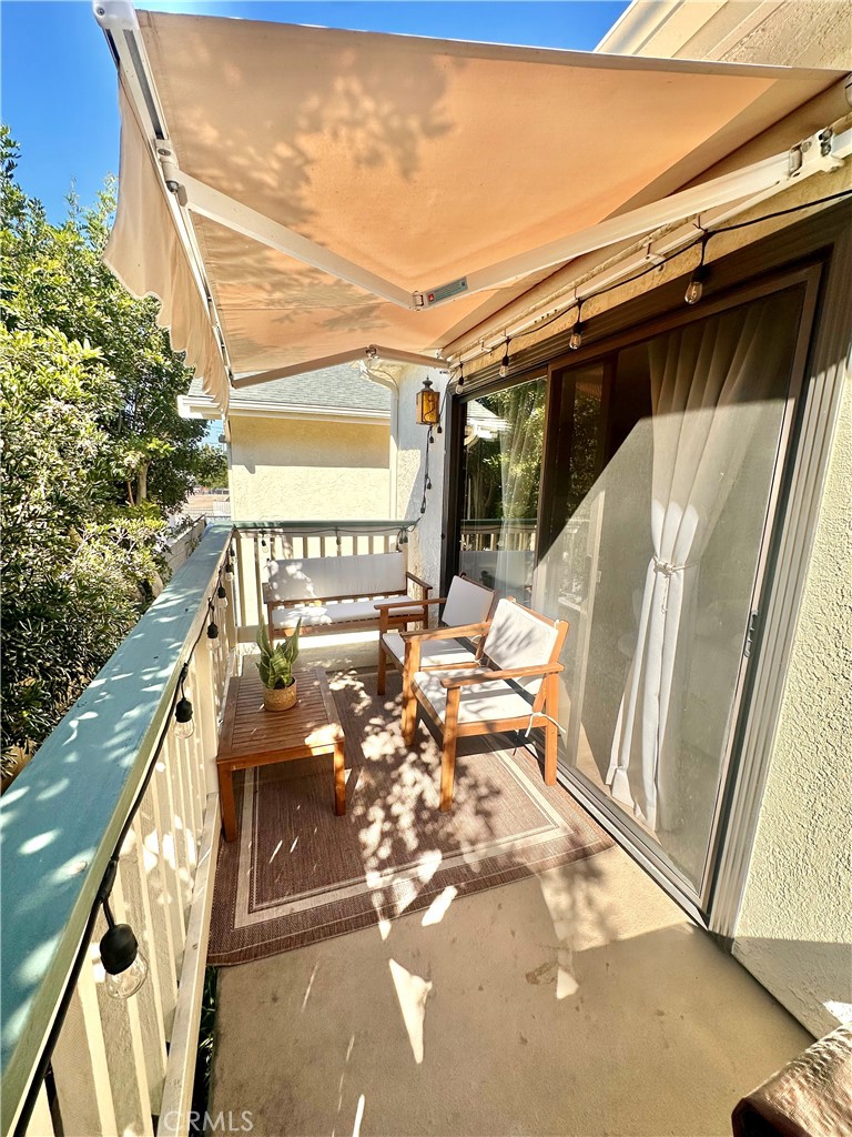 1045 East 3rd Street, Unit 4 Long Beach, CA 90802 - Photo 17 of 20 a view of balcony with wooden floor and furniture