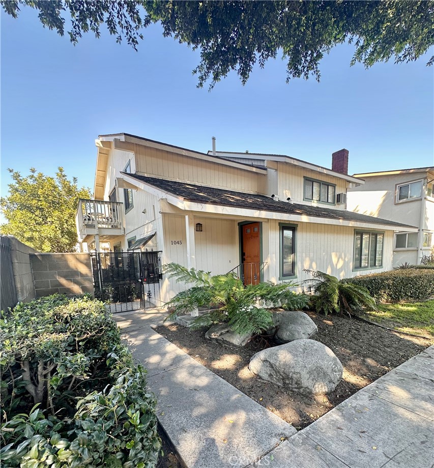 1045 East 3rd Street, Unit 4 Long Beach, CA 90802 - Photo 2 of 20 a front view of a house with a yard