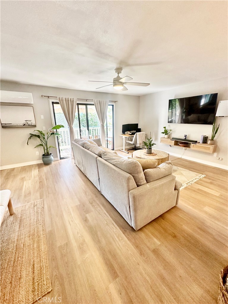 1045 East 3rd Street, Unit 4 Long Beach, CA 90802 - Photo 7 of 20 a living room with furniture and a flat screen tv