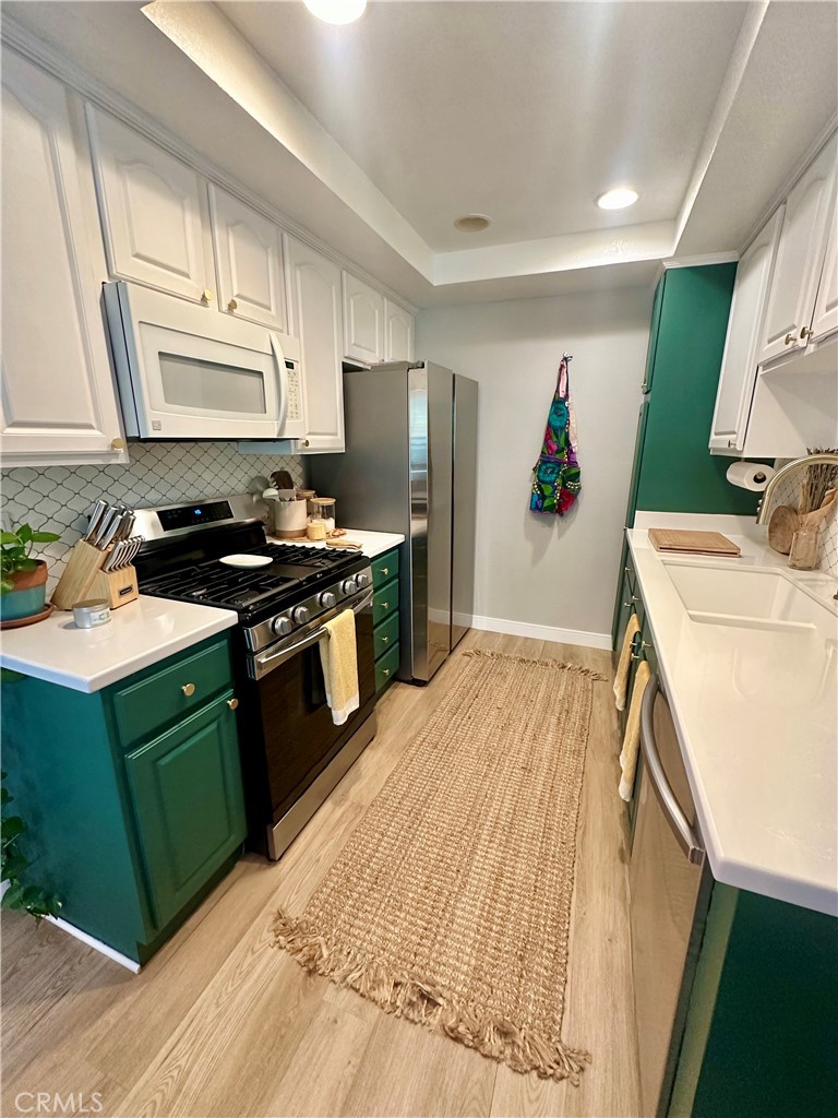 1045 East 3rd Street, Unit 4 Long Beach, CA 90802 - Photo 10 of 20 a kitchen with a sink stove and refrigerator