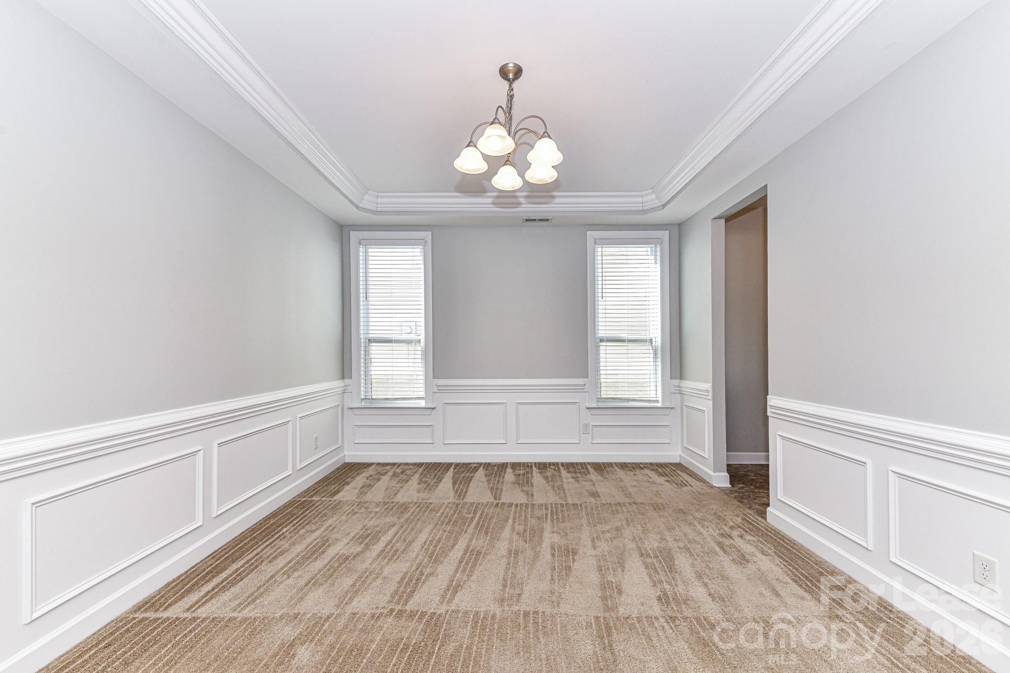 4316 Hubbard Road Charlotte, NC 28269 - Photo 11 of 46 a view of an empty room with wooden floor and a window