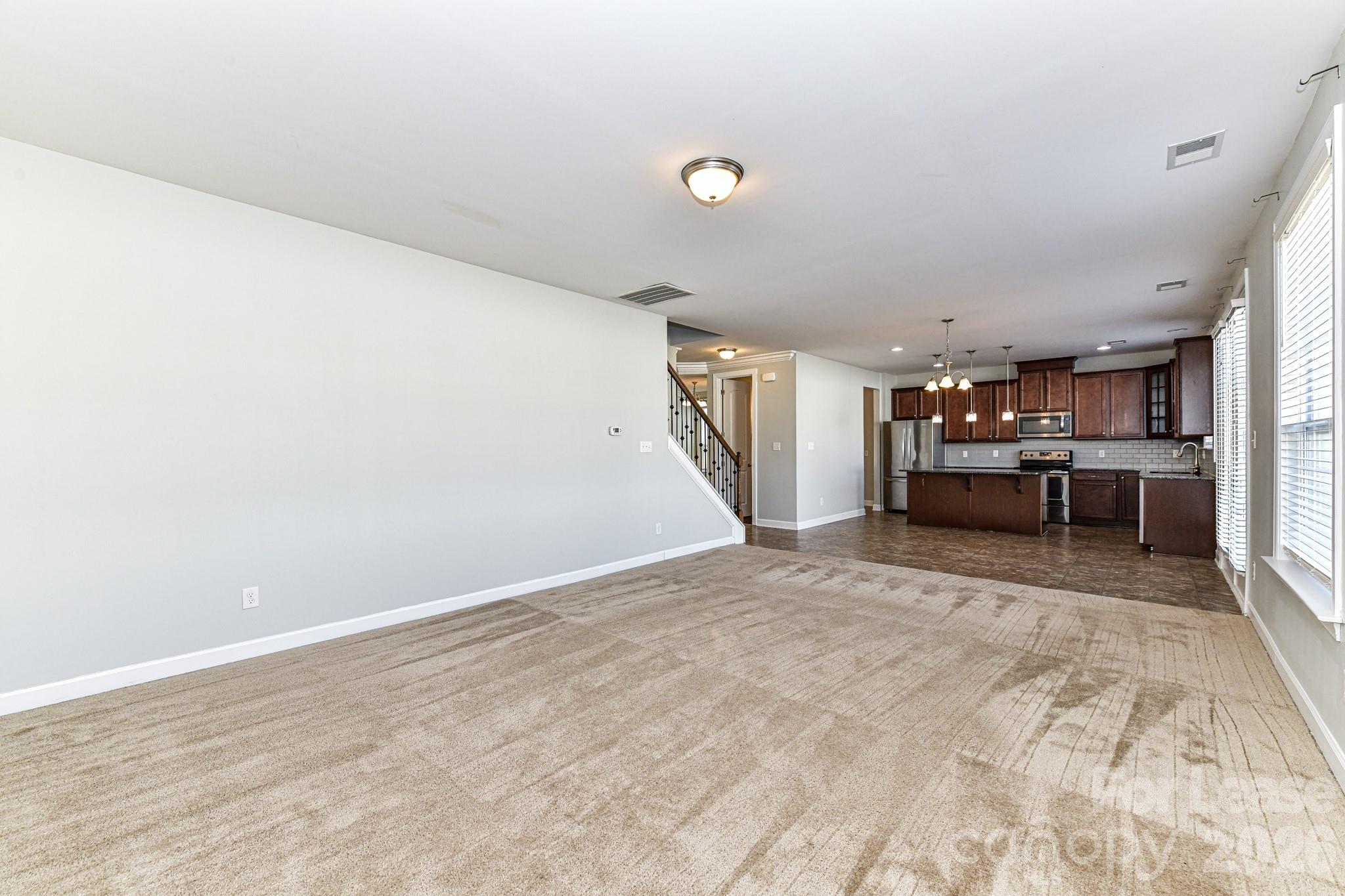 4316 Hubbard Road Charlotte, NC 28269 - Photo 15 of 46 a view of a livingroom with furniture and a kitchen