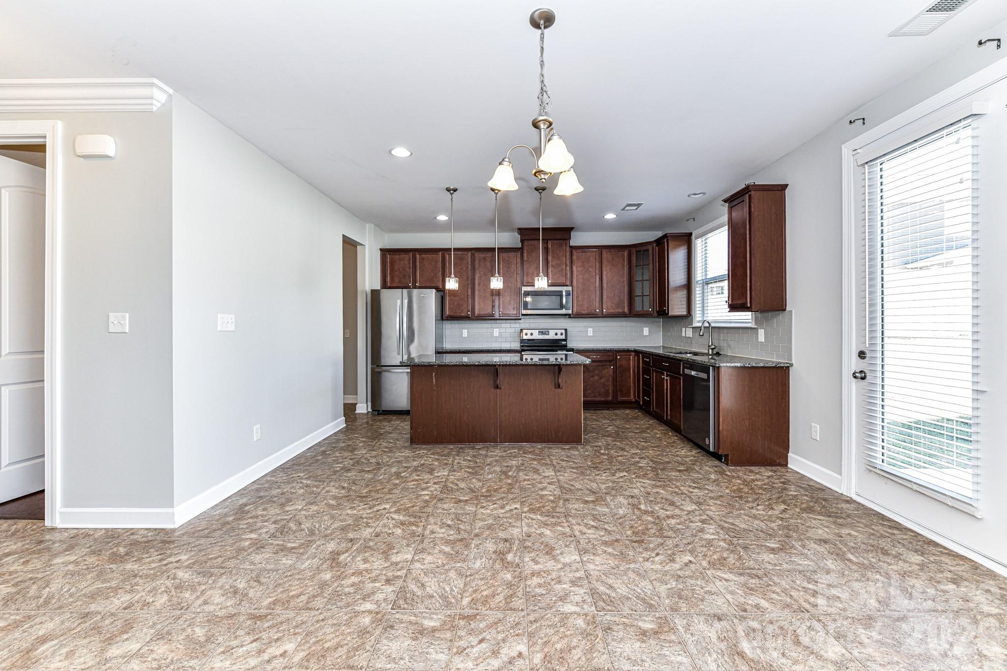 4316 Hubbard Road Charlotte, NC 28269 - Photo 16 of 46 a large kitchen with stainless steel appliances granite countertop a stove and a sink with granite countertops