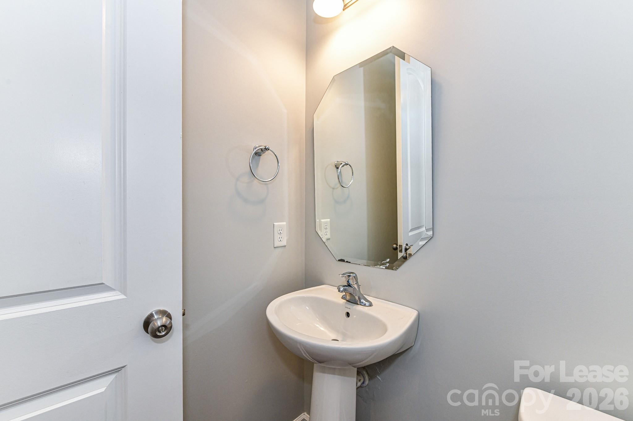 4316 Hubbard Road Charlotte, NC 28269 - Photo 22 of 46 a bathroom with a sink and a mirror