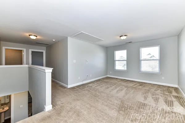 an empty room with windows and entrance