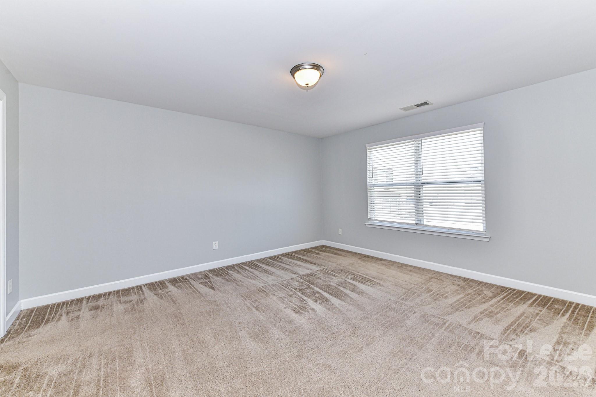 4316 Hubbard Road Charlotte, NC 28269 - Photo 26 of 46 an empty room with windows