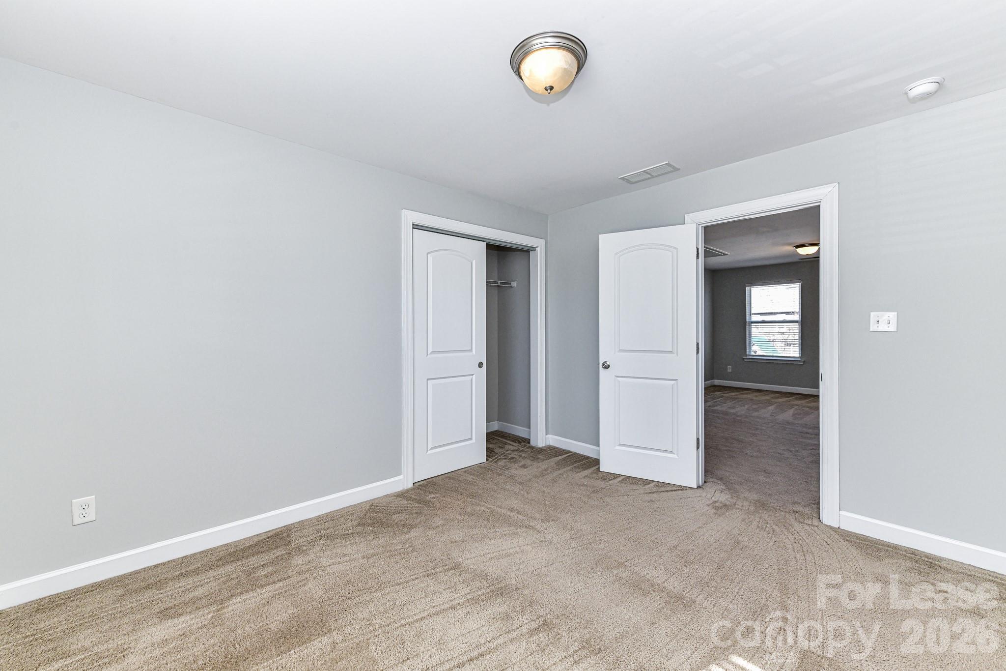 4316 Hubbard Road Charlotte, NC 28269 - Photo 33 of 46 an empty room with windows and closet