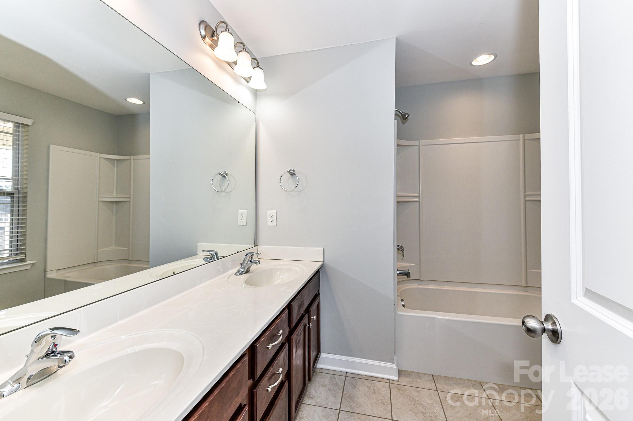 4316 Hubbard Road Charlotte, NC 28269 - Photo 34 of 46 a bathroom with a bathtub shower sink and a mirror