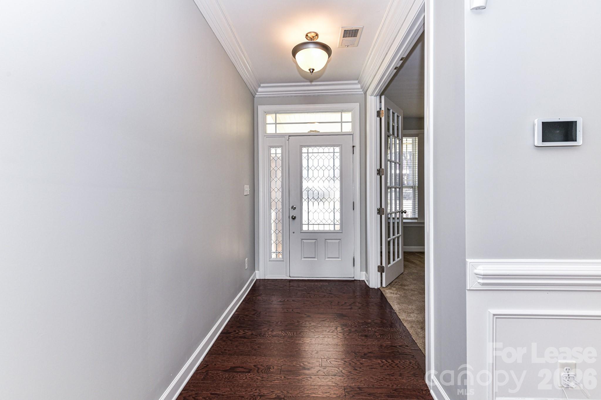 4316 Hubbard Road Charlotte, NC 28269 - Photo 6 of 46 a view of a hallway with wooden floor and a door