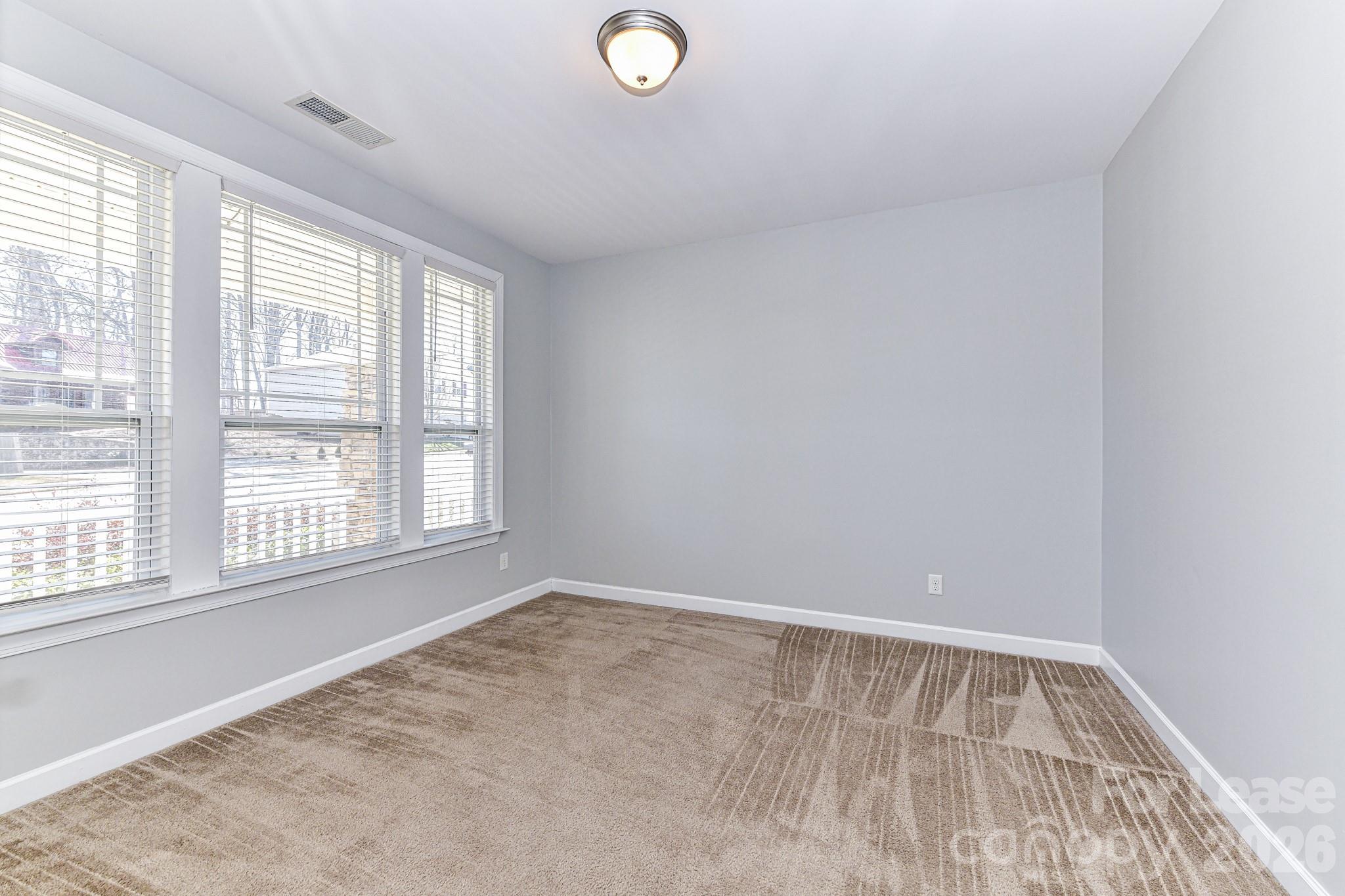 4316 Hubbard Road Charlotte, NC 28269 - Photo 8 of 46 an empty room with a window