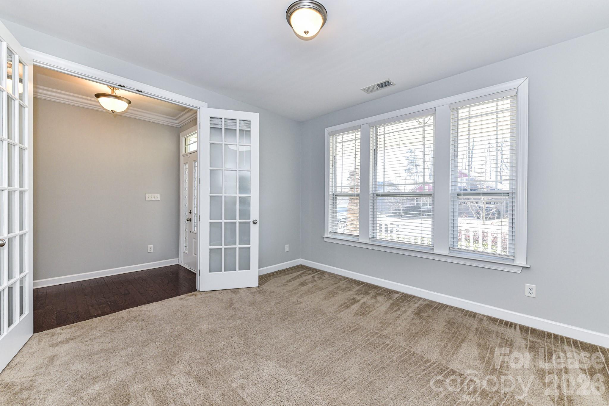 4316 Hubbard Road Charlotte, NC 28269 - Photo 9 of 46 a view of an empty room with a window