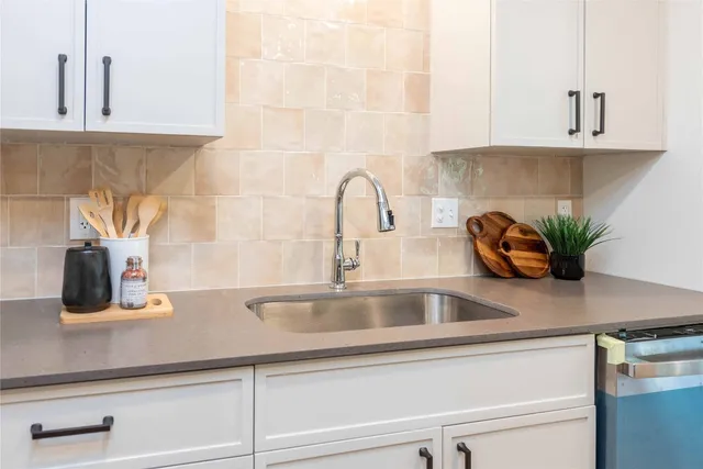 a kitchen with a sink and cabinets