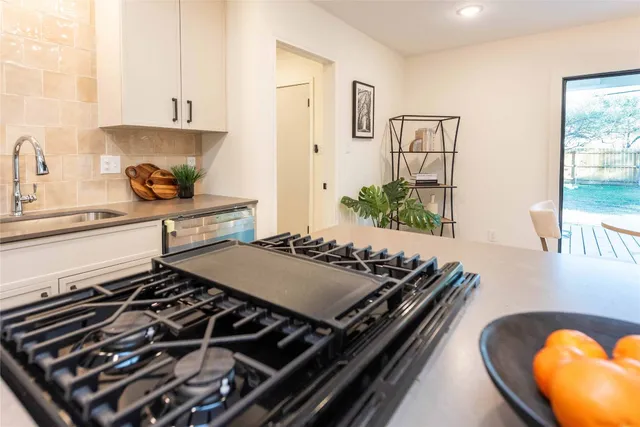 a kitchen with stove and cabinets