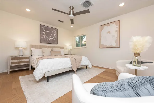 a bedroom with a bed couch and a window