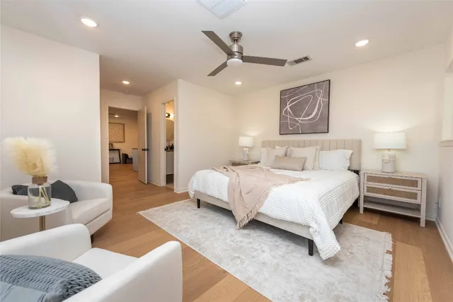 a spacious bedroom with a bed and a couch