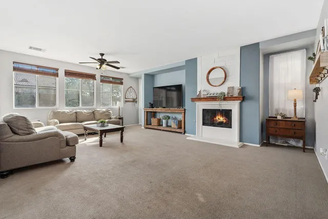 a living room with furniture and a fireplace