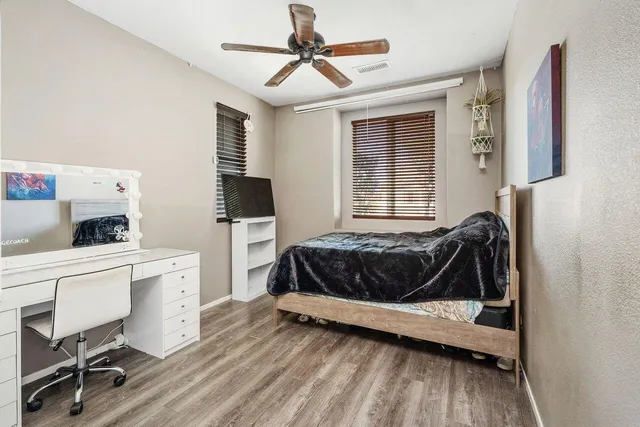 a bedroom with a bed and a desk